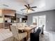 Dining area features a ceiling fan and sliding glass doors to the outdoor area at 7613 Bramblewood Dr, Port Richey, FL 34668