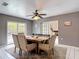 Dining area showcasing a wooden table and access to the backyard through sliding glass doors at 7613 Bramblewood Dr, Port Richey, FL 34668