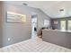 Hallway leading to various rooms, decorated with beach-themed artwork and neutral color palette at 7613 Bramblewood Dr, Port Richey, FL 34668