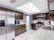 Kitchen featuring stainless steel appliances, tile floor, and plentiful counter and cabinet space at 7613 Bramblewood Dr, Port Richey, FL 34668