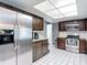 Kitchen showcasing stainless steel appliances, tile flooring, and plenty of counter space at 7613 Bramblewood Dr, Port Richey, FL 34668
