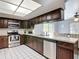 Well-lit kitchen with stainless steel appliances, tile flooring, and ample counter space at 7613 Bramblewood Dr, Port Richey, FL 34668