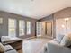 Bright living room with wood floors, ample natural light from three large windows and neutral decor at 7613 Bramblewood Dr, Port Richey, FL 34668