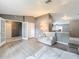 Inviting living room with light gray walls, wood floors, comfortable seating, and an open layout to the kitchen at 7613 Bramblewood Dr, Port Richey, FL 34668