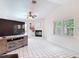 Bright living room features tiled fireplace, windows and neutral decor at 7613 Bramblewood Dr, Port Richey, FL 34668