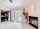 Open living area with sliding doors to the pool and a cozy tiled fireplace at 7613 Bramblewood Dr, Port Richey, FL 34668