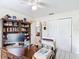 Spacious office with large desk, shelving, tiled floors, and natural light at 7613 Bramblewood Dr, Port Richey, FL 34668