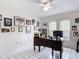 Bright office space with a large desk, natural light, and decorative wall art at 7613 Bramblewood Dr, Port Richey, FL 34668