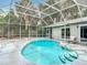 Backyard oasis with a sparkling pool, surrounded by a screened enclosure at 7613 Bramblewood Dr, Port Richey, FL 34668