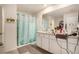 Neutral toned bathroom with a shower-tub combination and a large vanity with generous storage at 7639 Broad Pointe Dr, Zephyrhills, FL 33540