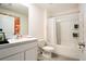 Bright bathroom features a shower-tub combo, framed mirror and a modern white vanity with countertop at 7639 Broad Pointe Dr, Zephyrhills, FL 33540