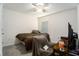 Cozy bedroom with neutral carpeting, a ceiling fan, and lots of natural light at 7639 Broad Pointe Dr, Zephyrhills, FL 33540