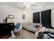 Guest bedroom with a daybed, ceiling fan, and modern decor with a view out the window at 7639 Broad Pointe Dr, Zephyrhills, FL 33540