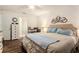 Bright bedroom featuring hardwood floors, a ceiling fan, and tasteful decorations at 7639 Broad Pointe Dr, Zephyrhills, FL 33540