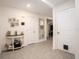 Welcoming entryway with neutral tile flooring, console table, and easy access to living areas at 7639 Broad Pointe Dr, Zephyrhills, FL 33540