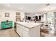 Inviting kitchen with center island and seating that transitions to dining room and living room at 7639 Broad Pointe Dr, Zephyrhills, FL 33540