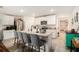 Bright kitchen with stainless steel appliances, white cabinets, a large island with seating, and tile flooring at 7639 Broad Pointe Dr, Zephyrhills, FL 33540
