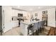 Bright kitchen featuring white cabinetry, granite countertops and island with seating for casual dining at 7639 Broad Pointe Dr, Zephyrhills, FL 33540