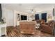 Comfortable living room with wood-look floors, a built-in entertainment center, and a relaxing atmosphere at 7639 Broad Pointe Dr, Zephyrhills, FL 33540