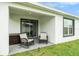 Covered patio has furniture, sliding glass door, window and is great for enjoying outdoor living at 7639 Broad Pointe Dr, Zephyrhills, FL 33540