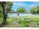 Exterior view of home featuring a spacious backyard with mature trees offering privacy and a serene outdoor setting at 7702 New York Dr, Tampa, FL 33619