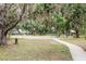 Community park featuring a basketball court, playground, and shaded seating areas, perfect for outdoor activities at 7702 New York Dr, Tampa, FL 33619