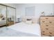 Bedroom with stylish decor, featuring a comfortable bed with soft pillows, neutral tones, and ample storage space at 7702 New York Dr, Tampa, FL 33619