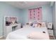 Bright bedroom with butterfly-themed decor, soft lighting, and ample space for personalization creates a cheerful atmosphere at 7702 New York Dr, Tampa, FL 33619