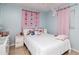 Well-lit bedroom with butterfly-themed decor offers a cheerful and inviting space for relaxation and personalization at 7702 New York Dr, Tampa, FL 33619