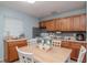 Cozy kitchen with wooden cabinets, a dining table, and essential appliances at 7702 New York Dr, Tampa, FL 33619