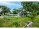 Landscaped yard with lush greenery and trees, complemented by a charming fence at 7702 New York Dr, Tampa, FL 33619