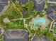 Resort-style pool with a fountain feature, jacuzzi, palm trees, lounge chairs and landscaped walkway at 820 Normandy Trace Rd, Tampa, FL 33602