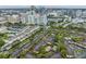 An aerial view overlooking mature trees, condos with parking, and city skyline at 820 Normandy Trace Rd, Tampa, FL 33602