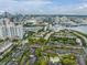 An aerial view of the condo community with a pool, with downtown skyline, and green landscaping at 820 Normandy Trace Rd # 820, Tampa, FL 33602