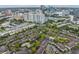An aerial view of a condo community featuring downtown skyline, mature trees, and pool at 820 Normandy Trace Rd, Tampa, FL 33602