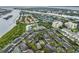 An aerial view featuring waterway, condo buildings with a tennis court, and trees at 820 Normandy Trace Rd, Tampa, FL 33602