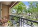 Cozy balcony with seating overlooks lush landscaping and serene neighborhood views at 820 Normandy Trace Rd, Tampa, FL 33602