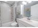 Clean bathroom with a shower-tub combo, white tile, and vanity with storage at 820 Normandy Trace Rd, Tampa, FL 33602