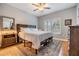 Cozy bedroom features a wooden headboard, neutral walls, and window shutters at 820 Normandy Trace Rd, Tampa, FL 33602