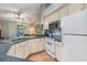 Kitchen with white cabinets, tile floor, eat-in area, sliding door to balcony, and view to Gathering room at 820 Normandy Trace Rd, Tampa, FL 33602