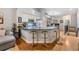 Open kitchen with breakfast bar, counter seating, modern appliances, hardwood floors, and view to living room at 820 Normandy Trace Rd, Tampa, FL 33602