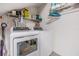 Bright laundry room featuring a new washer and dryer, wire shelving and ample storage space at 820 Normandy Trace Rd, Tampa, FL 33602