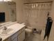 A bathroom showing a toilet, sink, vanity mirror, and a shower curtain at 9100 Mlk N St # 503, St Petersburg, FL 33702