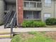 Exterior view of a residential building showcasing staircases, screened balconies, and maintained landscaping at 9100 Mlk N St # 503, St Petersburg, FL 33702