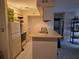 View of the kitchen with white appliances, countertops, modern lighting and breakfast bar area at 9100 Mlk N St # 503, St Petersburg, FL 33702