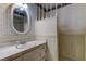 Bathroom featuring a vanity with marble counter and white wicker framed mirror at 9918 Davis Rd, Tampa, FL 33637