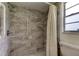 Bathroom includes granite tile shower and white shower curtain at 9918 Davis Rd, Tampa, FL 33637