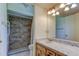 Bathroom with granite tile shower, and single sink vanity at 9918 Davis Rd, Tampa, FL 33637