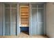Bedroom closet with light blue wooden doors and built in desk area at 9918 Davis Rd, Tampa, FL 33637