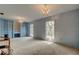 Bright bedroom with blue walls, built-in storage, chandelier lighting, and large windows at 9918 Davis Rd, Tampa, FL 33637